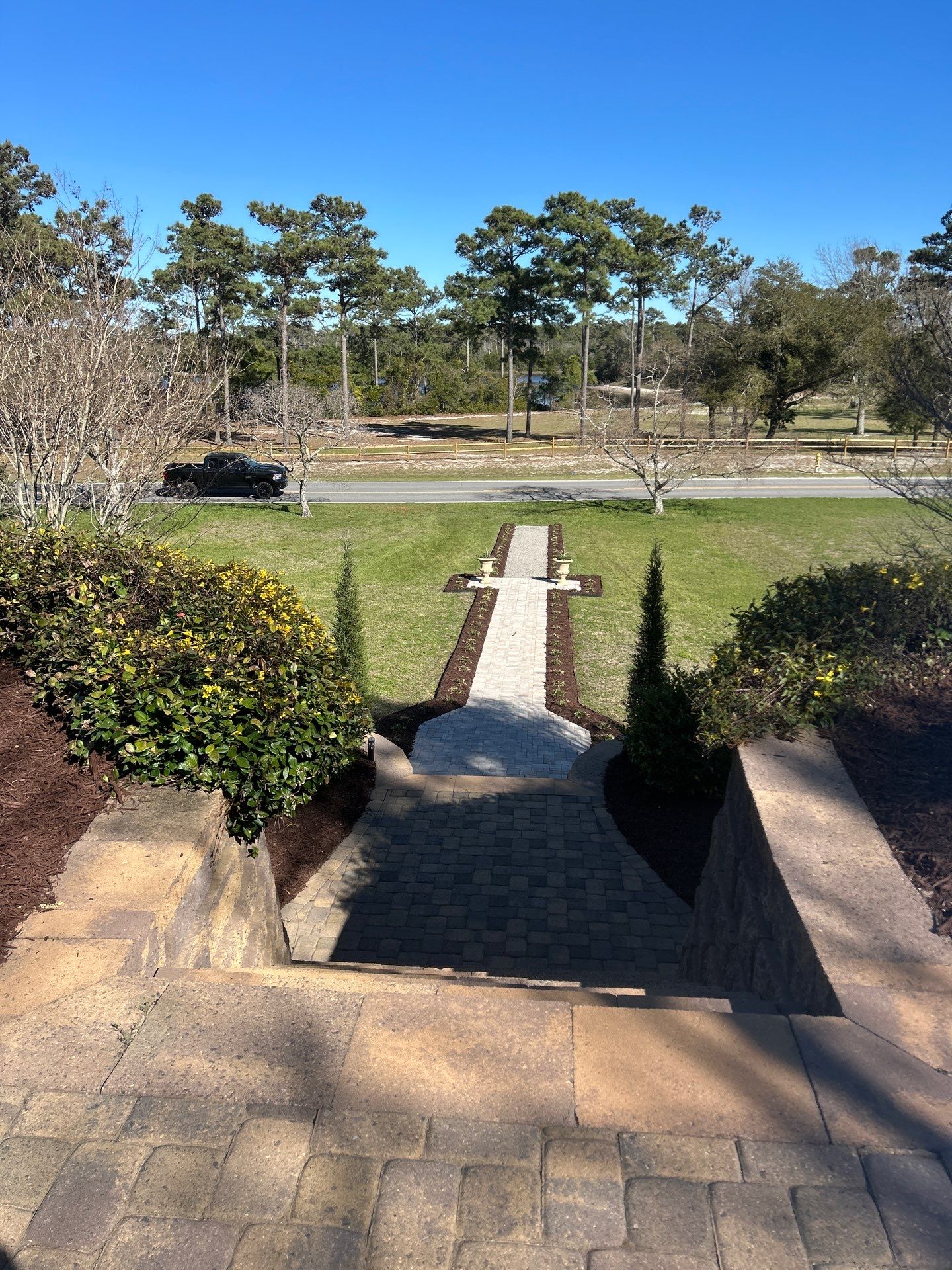 Fresh front walkway and planting beds leading from a home toward the street